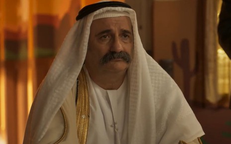 Gillray Coutinho com expressão séria e vestes árabes em cena como sheik Omar da novela Mar do Sertão