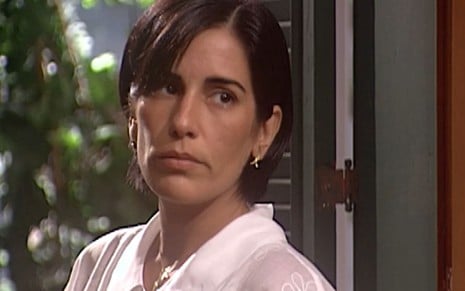 Gloria Pires caracterizada como Rafaela; ela tem o cabelo na altura do queixo e usa uma regata branca em cena de O Rei do Gado