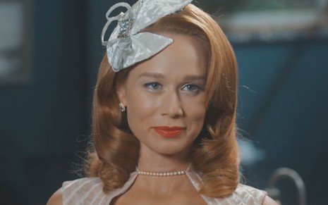 Mariana Ximenes caracterizada como Gilda em Amor Perfeito; ela usa os cabelos ruivos na altura dos ombros e um batom vermelho bem marcado