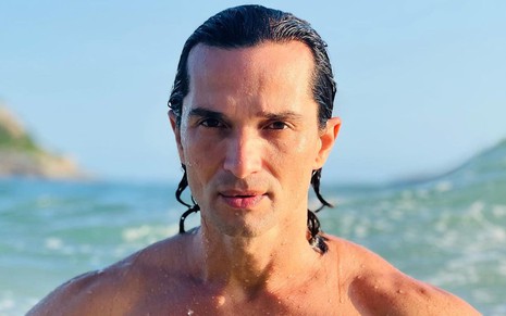 Foto do rosto de Jeff Machado, ele está sem camisa e molhado em uma praia