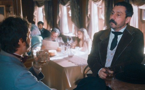 Tonico Rocha (Alexandre Nero) conversa com Nélio (João Pedro Zappa) dentro de navio em cena de Nos Tempos do Imperador