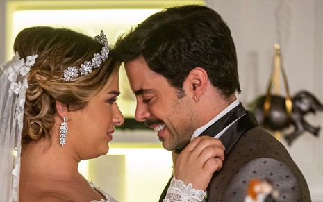Os atores Glamour Garcia e Pedro Carvalho vestidos de noivos para o casamento de seus personagens na novela A Dona do Pedaço