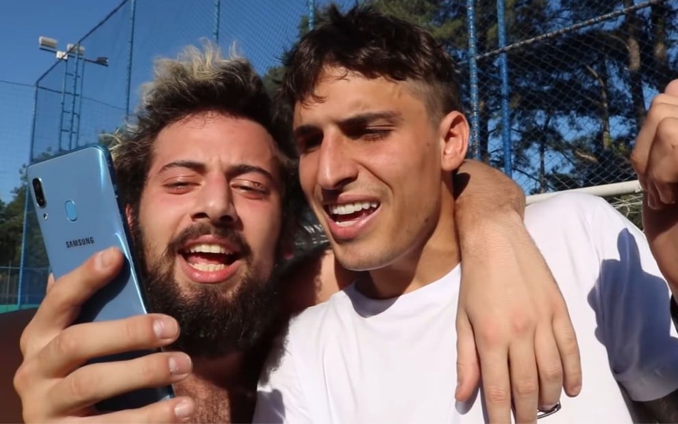 Imagem de Cartolouco e Felipe Prior abraçados enquanto gravam um vídeo