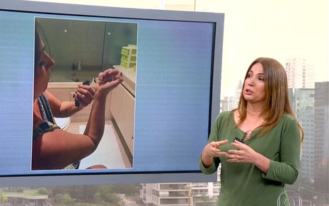 Ananda Apple de blusa verde no estúdio do Bom Dia SP, mostrando resgate de sabiá no telão