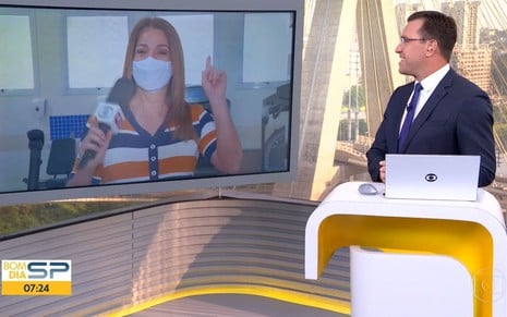 Ananda Apple de máscara, no telão do Bom Dia SP, conversando com Rodrigo Bocardi