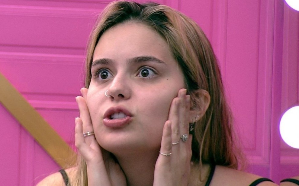 Viih Tube coloca as mãos no rosto com expressão de assustada enquanto conversa no BBB21, da Globo