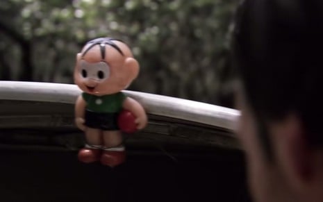 Um boneco de Cebolinha, da Turma da Mônica, segurando uma bola preso a um barco no filme Medo Profundo