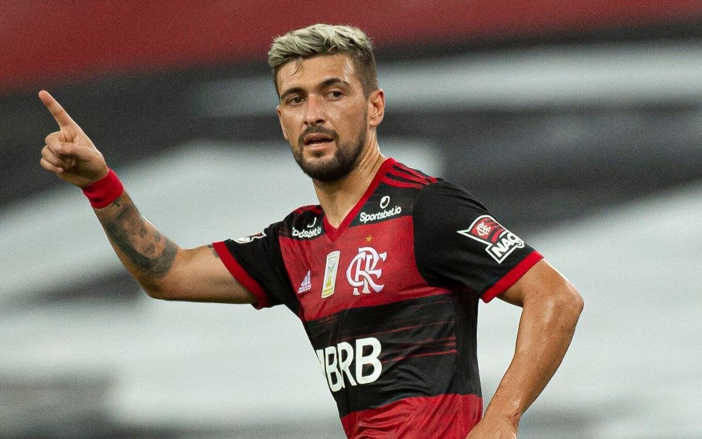 O meia Arrascaeta aponta para a frente em comemoração de gol do Flamengo no Brasileirão