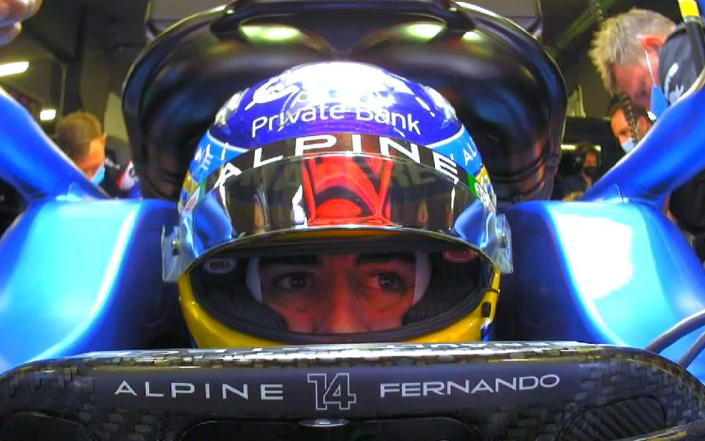 Fernando Alonso de capacete e dentro de seu carro com olhar concentrado