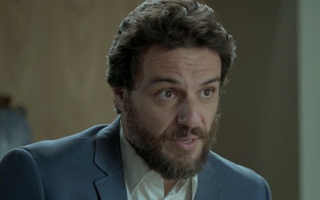 O ator Rodrigo Lombardi, com os olhos arregalados, em cena como Caio em A Força do Querer