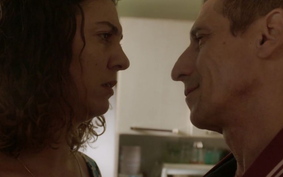 Os atores Clarissa Pinheiro (à esquerda) e Tuca Andrada (à direita) se olham como os personagens Penha e Belizário, respectivamente, em cena de Amor de Mãe: