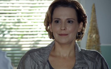 A atriz Ana Beatriz Nogueira, sentada, com expressão de satisfação, durante gravação de cena como Eva de A Vida da Gente.