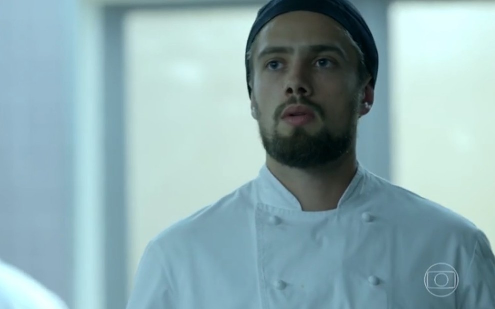O ator Rafael Cardoso, com roupa de chef de cozinha, em cena como Vicente em Império