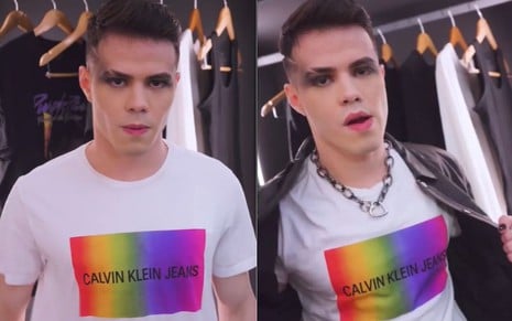 Gustavo Rocha com maquiagem preta nos olhos, corrente no pescoço, camiseta com arco-íris e jaqueta