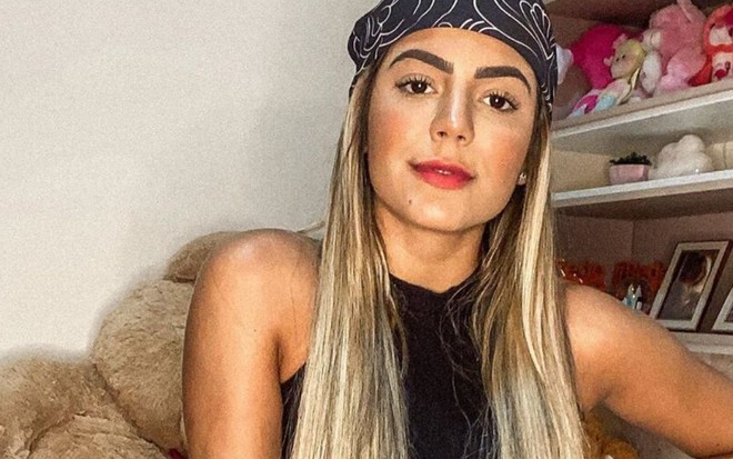 Imagem de Hariany Almeida com cabelo solto e lenço preto na cabeça