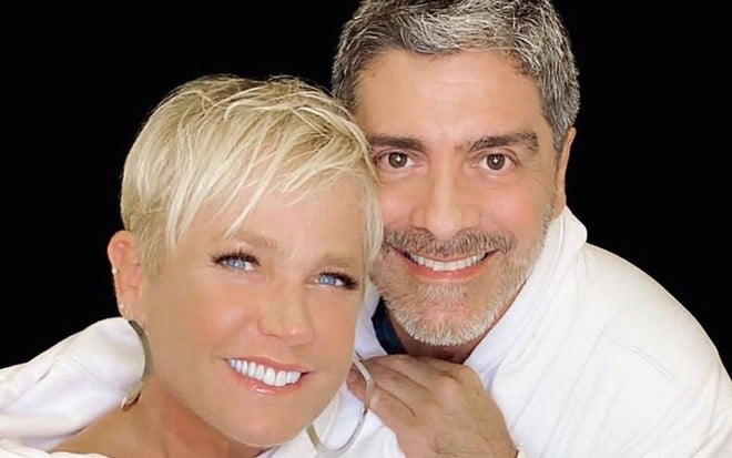 O casal de artistas Xuxa Meneghel e Junno Andrade sorri abraçado em foto publicada no Instagram