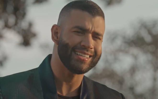 O sertanejo Gusttavo Lima olha pra câmera enquanto canta no clipe Saudade Sua, disponível no YouTube