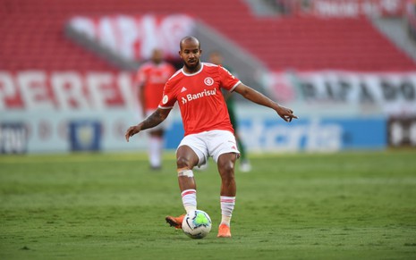 O jogador do Internacional Patrick em lance com a bola no pé, vestindo o uniforme do time nas cores vermelho e branco