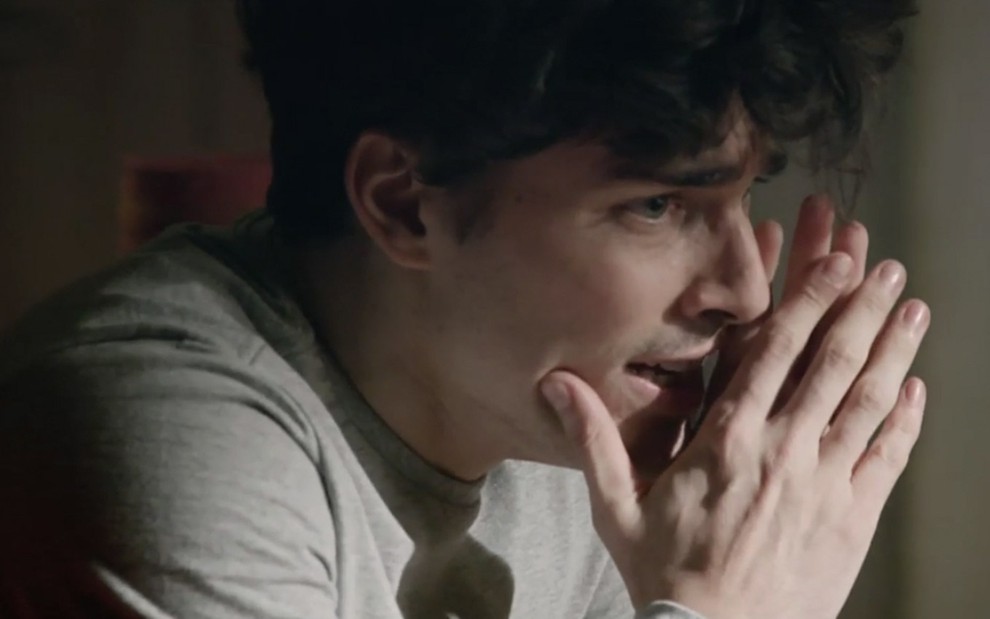 Miguel Coelho em cena de Amor Sem Igual: caracterizado como o personagem Antônio Junior, ator tem olhar de atordoado e coloca as mãos na frente do corpo