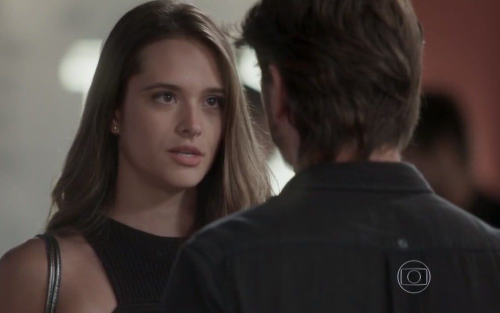 Cassandra (Juliana Paiva) com a expressão séria diante de Rafael (Daniel Rocha) em cena de Totalmente Demais