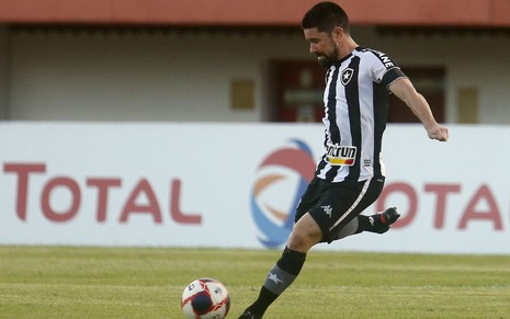 O jogador do Botafogo, Ricardinho, em lance no campo vestido com o uniforme do time nas cores preto e branco