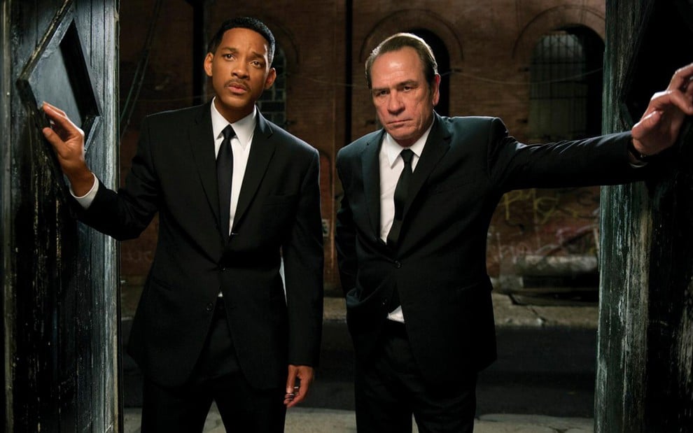 Will Smith e Tommy Lee Jones em cena de Homens de Preto 3, caracterizados como seus personagens