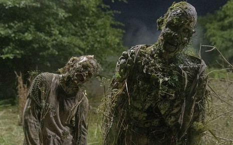 Dois zumbis andam cambaleantes e cobertos de mato na décima temporada de Walking Dead