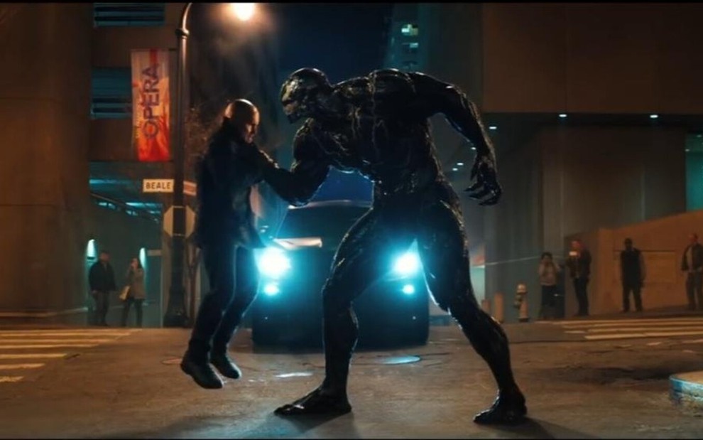 Tom Hardy como o anti-herói estrangulando um homem em cena de Venom