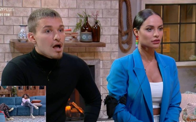 MC Gui veste blusa preta e está com a boca aberta; Aline olha para frente, veste top branco e terno azul