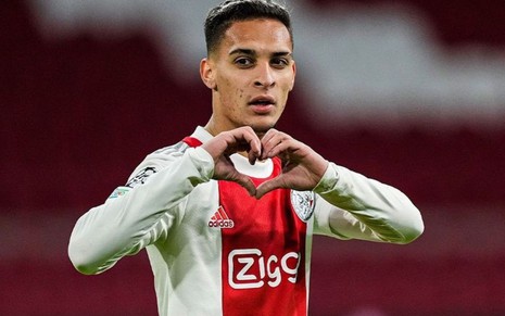 Antony, do Ajax, veste uniforme branco com faixa vermelha e comemora gol fazendo sinal de coração