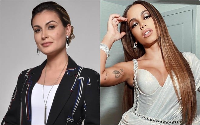 Andressa está na frente de uma parede branca, veste terno preto e regata branca; Anitta olha para baixo, usa macacão brilhante na cor branca e está na frente de uma parede branca