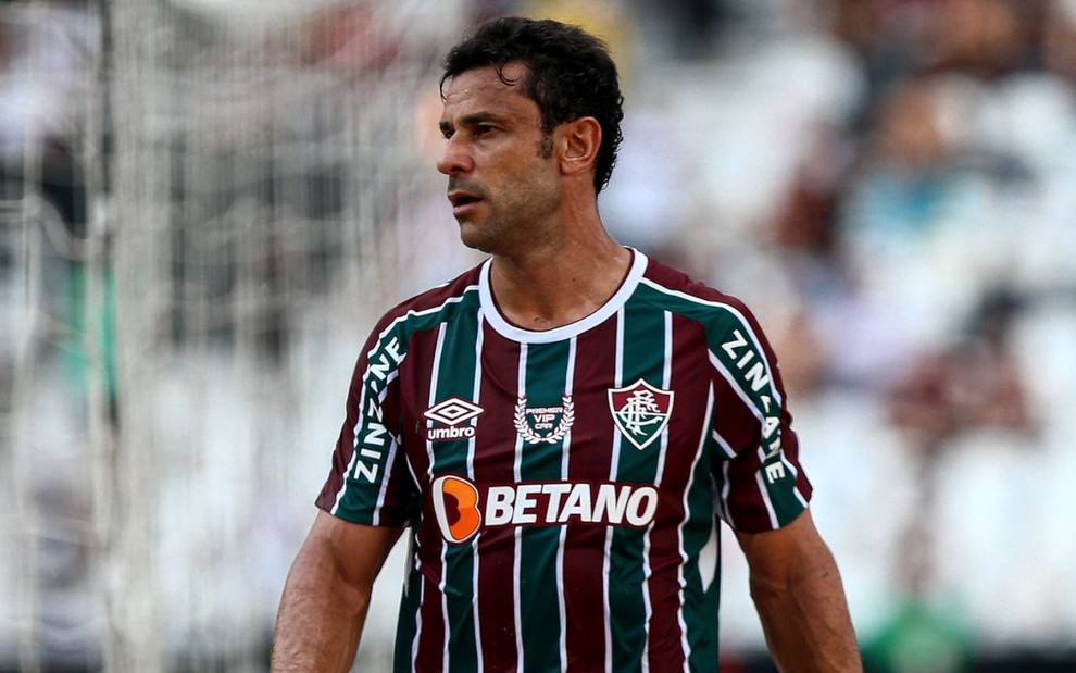 Jogador Fred, do Fluminense, veste uniforme listrado em branco, verde e grená durante partida da equipe