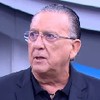 Galvão Bueno com um terno azul e uma camisa preta no Bem, Amigos!, do SporTV
