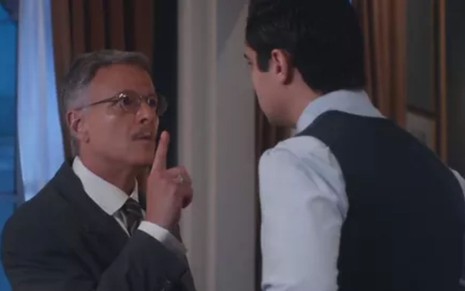 Eugênio (Marcello Novaes) aponta o dedo para Joaquim (Danilo Mesquita), que está de costas na foto, em cena de Além da Ilusão
