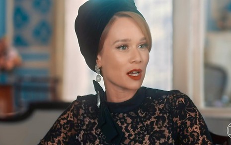 Mariana Ximenes está vestida de preto e usa turbante na cabeça em cena da novela Amor Perfeito como a vilã Gilda