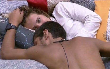 Bruna Griphao e Gabriel Santana deitados no sofá enquanto Gabriel faz cafuné na atriz