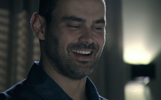 Carmo Dalla Vecchia grava cena sorrindo, como Maurílio em Império, da Globo