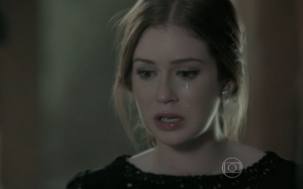 Maria Isis (Marina Ruy Barbosa) chora em cena de Império em que está com cabelo preso e olha para baixo