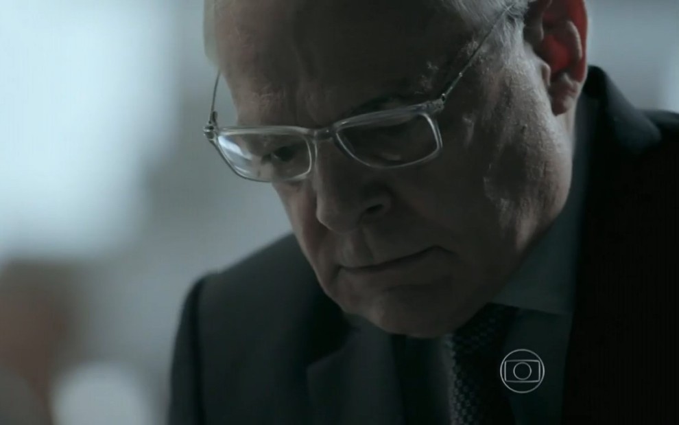 Othon Bastos grava com terno, óculos de grau, careca e expressão de raiva como Silviano de Império, reprise da Globo