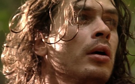 Fabio Assunção caracterizado como Marcos; ele está suado, sujo e empapado em lama em cena de O Rei do Gado. O semblante está transtornado.