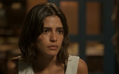 Guta (Julia Dalavia) tem expressão de tristeza em cena de Pantanal, novela das nove da Globo