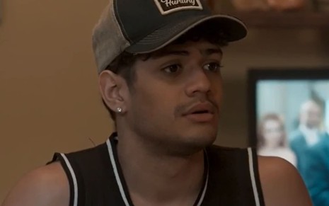 Gabriel Santana, caracterizado como Renato, tem a expressão emburrada em cena de Pantanal