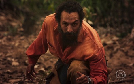 Irandhir Santos em cena de Pantanal: ator está encarando algo que esta fora da imagem da novela