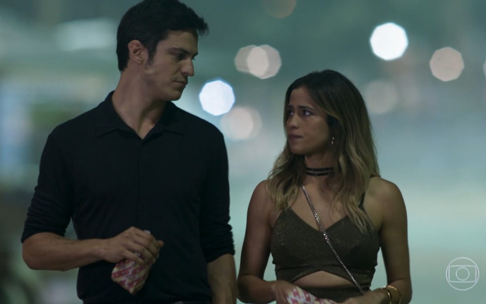Mateus Solano e Nanda Costa gravam em cena externa noturna com pipoca na mão como Eric e Sandra Helena de Pega Pega