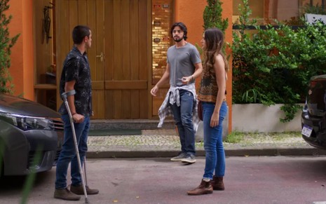 Felipe Simas grava com muletas olhando para Juliana Paiva e Rodrigo Simas como Téo, Luna e Alejandro, respectivamente
