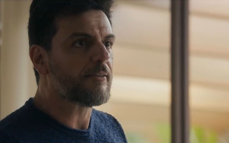 Rodrigo Lombardi caracterizado como Moretti; ator tem as sobrancelhas franzidas e o rosto comprimido de raiva em cena de Travessia