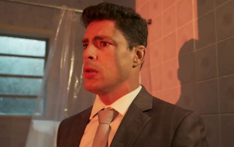 Cauã Reymond em cena de Um Lugar ao Sol: ator está caracterizado como Renato, em close e olha com aflição para frente