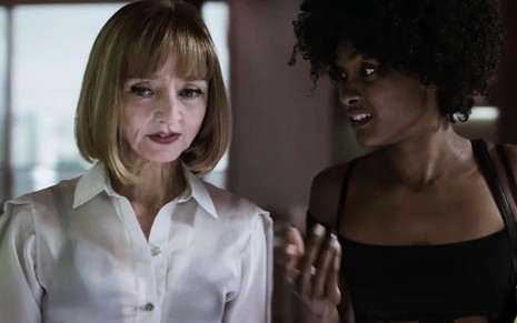 A atriz Maria de Medeiros está de camisa branca contracenando com Erika Januza, que usa blusa preta em cena de Verdades Secretas 2
