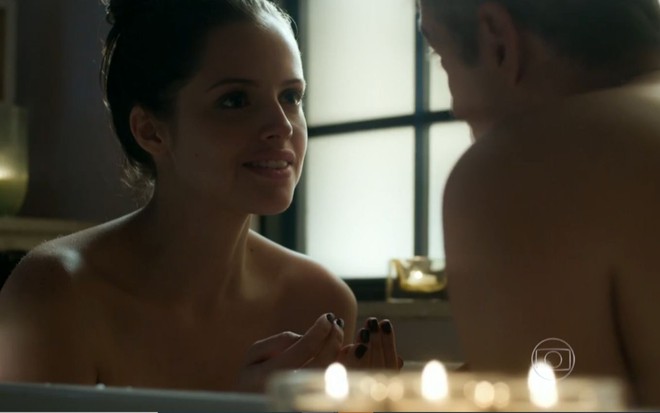 Agatha Moreira grava cena com Reynaldo Gianecchini, que aparece de costas na imagem, com sorriso falso, como Giovanna e Anthony