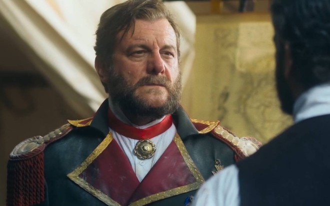 Ator Roberto Birindelli olha para frente com cara de sério em cena de Nos Tempos do Imperador